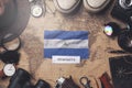 Nicaragua Flag Between Traveler`s Accessories on Old Vintage Map. Overhead Shot