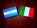 Nicaraguan flag with Italian flag on a tree stump isolated