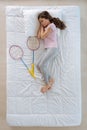 Nice active girl dreaming of playing badminton