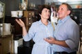 nice adult woman with her husband are buying furniture in antique store Royalty Free Stock Photo