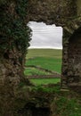 Nice aerial view of an old rural cemetery from the ruins of a stone building. Irish landscape