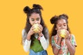 Nice afro american girls biting their apples