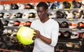 Nice Afro man choosing biker accessories