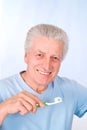 Nice aged guy brushes teeth