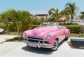 nice amazing closeup view of classic vintage pink car near the swimming pool area, sunny beautiful day