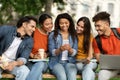 Nice App. Group Of Multiethnic Students Using Smartphone Together Outdoors Royalty Free Stock Photo