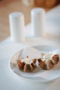 Nice appetizer snacks - tartlets on a white ceramic plate. Royalty Free Stock Photo