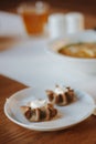 Nice appetizer snacks - tartlets on a white ceramic plate. Royalty Free Stock Photo