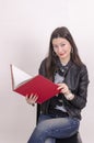 Nice asian girl in black jacket with a red book. Royalty Free Stock Photo