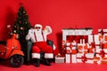 Nice attractive fat overweight cheerful Santa father sitting in armchair showing time fast delivery holly jolly festal