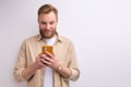 nice attractive young man holding mobile phone in hands creating social strategy influencer thinking Royalty Free Stock Photo