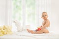 Baby in diaper playing with rubber toy Royalty Free Stock Photo