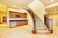 Nice basement staircase with metal railing and beige carpet. Royalty Free Stock Photo