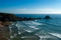 Nice beach with lots of waves and people surfing