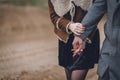 A nice beautiful couple lovers in the park or field or track. man in Gray coat and scarf with girl woman in brown coat. lovely