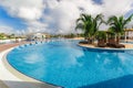 Nice beautiful inviting view of a curved comfortable swimming pool with ceramic beds