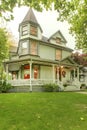 Nice big green home with porch and white railings Royalty Free Stock Photo