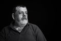 Black and white portrait of a thoughtful senior man