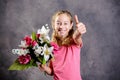 Nice blond girl bouquet of flowers and thumb up Royalty Free Stock Photo