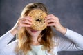 Blond girl looking through a big bagel Royalty Free Stock Photo