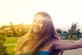 Nice blond haired lady closed eyes posing outside in the park backlit by summer sun Royalty Free Stock Photo