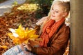 Nice blonde girl in autumn park Royalty Free Stock Photo
