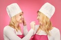 Pretty blonde twins posing for double portrait as bakers Royalty Free Stock Photo