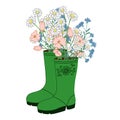 A nice bouquet of flowers in beautiful green rubber boots.