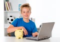 Nice boy with laptop and piggy bank Royalty Free Stock Photo