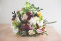 Nice bridal bouquet with garden roses, carnations, freesias and greenery