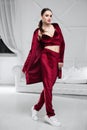 Nice brunette dressed in a burgundy velor suit Royalty Free Stock Photo