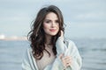 Nice brunette lady outdoor portrait. Healthy woman against blue sea and sky cloud background Royalty Free Stock Photo