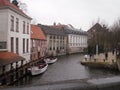 Nice Canal With Boats Moored On Their Piers In Bruges. March 23, 2013. Bruges, West Flanders, Belgium. Vacation Nature Street