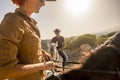 Nice caucasian cowboys couple ride horses in wind ladscape scenic place. woman and man together have fun with horse therapy and