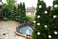 Nice central courtyard with fountain and flagstone patio and evergreen trees Royalty Free Stock Photo