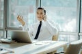 Cheerful man having a pleasant phone conversation in office Royalty Free Stock Photo