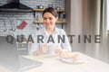 Nice cheerful businesswoman sit at table in kitchen and look at laptop. She works at home. Model hold white cup with