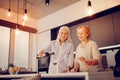 Nice cheerful woman pouring wine in the glass Royalty Free Stock Photo