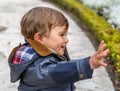 A nice child greets with his right hand