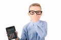 Nice child holding calculator. Portrait of funny cute schoolboy touching eye glasses.White background Royalty Free Stock Photo