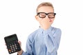 Nice child holding calculator. Portrait of funny cute schoolboy touching eye glasses.White background Royalty Free Stock Photo