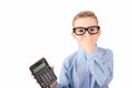 Nice child holding calculator. Portrait of funny cute schoolboy touching eye glasses.White background Royalty Free Stock Photo