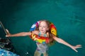 Nice child swiming in blue small pool. Girl have fun in water indoors Royalty Free Stock Photo