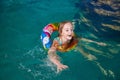 Nice child swiming in blue small pool. Girl have fun in water indoors Royalty Free Stock Photo