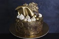 Nice chocolate gilded cake with merengues and sails