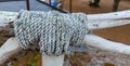 closeup textured detailed view of an old loop rope on wooden fence