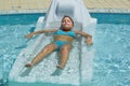 Nice closeup view of a pretty charming little girl taking sunbath and relaxing in outdoor spa swimming pool bed Royalty Free Stock Photo