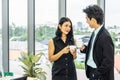 Nice coffee break, business woman drinking an espresso during a small talk with a young colleague while standing in office Royalty Free Stock Photo