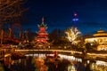 Christmas in Tivoli Amusement Park in Copenhagen, Denmark in the dark winter evening