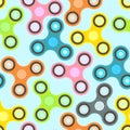 Nice colorful fidget spinners on light blue background seamless pattern